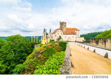 View of beautiful castle Vranov nad Dyji, Moravian region in Czech republic. Ancient chateau built in baroque style, placed on big rock above river near the Vranov village. Cloudy weather. 139050848