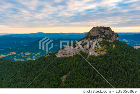 Aerial view to Mala Fatra mountains in Slovakia. Sunrise above mountain peaks and hills in far. Beautiful nature, vibrant colors. Famous tourist destination for hiking and trekking. Cloudy weather. Aerial view to Mala Fatra mountains in Slovakia. Sunrise above mountain peaks and hills in far. Beautiful nature, vibrant colors. Famous tourist destination for hiking and trekking. Cloudy weather. 139050869