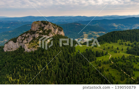 Aerial view to Mala Fatra mountains in Slovakia. Sunrise above mountain peaks and hills in far. Beautiful nature, vibrant colors. Famous tourist destination for hiking and trekking. Cloudy weather. Aerial view to Mala Fatra mountains in Slovakia. Sunrise above mountain peaks and hills in far. Beautiful nature, vibrant colors. Famous tourist destination for hiking and trekking. Cloudy weather. 139050879