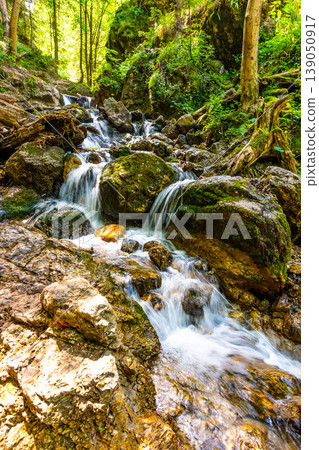 Beautiful pure waterfall in Slovakia national park Mala Fatra - Janosikove Diery, near the Terchova village. Fresh water stream on big rocks in green forest. Sunny summer day in fresh nature 139050917