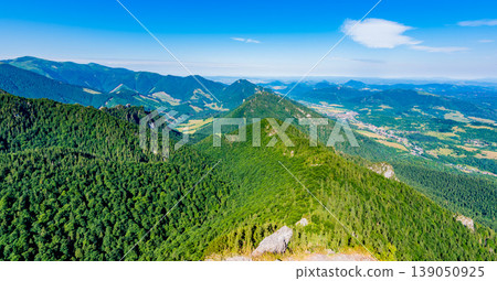 Slovakia national parkland Mala Fatra - view from Maly Rozsutec mountain to nearby hills and valleys. Sunny summer day, tourism and hiking in fresh and pure nature. Forest and green trees. 139050925