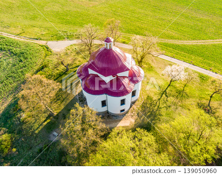 Aerial view of baroque chapel near Rosice city, Czech republic. Catholic religion building is national heritage of Czech republic. Sunny weather, agriculture land in background Aerial view of baroque chapel near Rosice city, Czech republic. Catholic religion building is national heritage of Czech republic. Sunny weather, agriculture land in background 139050960