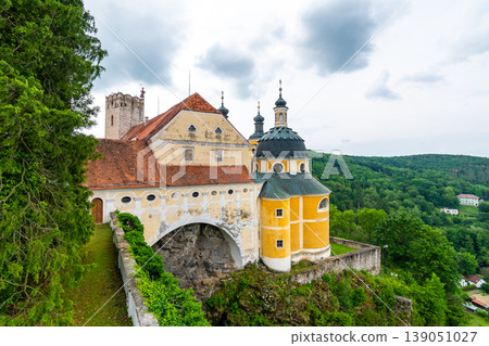 View of beautiful castle Vranov nad Dyji, Moravian region in Czech republic. Ancient chateau built in baroque style, placed on big rock above river near the Vranov village. Cloudy weather. View of beautiful castle Vranov nad Dyji, Moravian region in Czech republic. Ancient chateau built in baroque style, placed on big rock above river near the Vranov village. Cloudy weather. 139051027