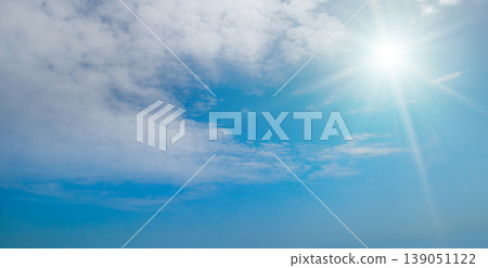 Clear blue sky with white fluffy clouds and bright radiant sun. Clear blue sky with white fluffy clouds and bright radiant sun. 139051122