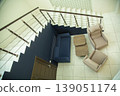 Top view of modern living room area with stairs and sofa. 139051174