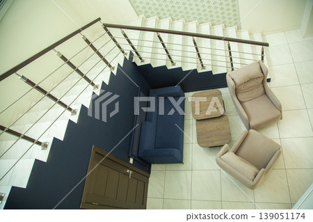 Top view of modern living room area with stairs and sofa. Top view of modern living room area with stairs and sofa. 139051174