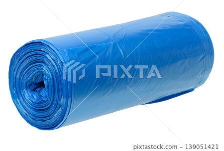 A roll of blue plastic garbage bags on an isolated background, tightly rolled 139051421