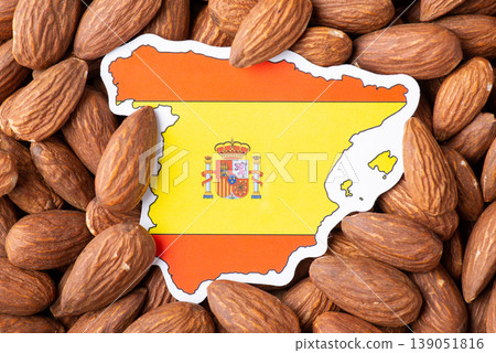 Small flag and map of Spain in almonds. Origin of nuts, agribusiness of growing almonds in Spain 139051816