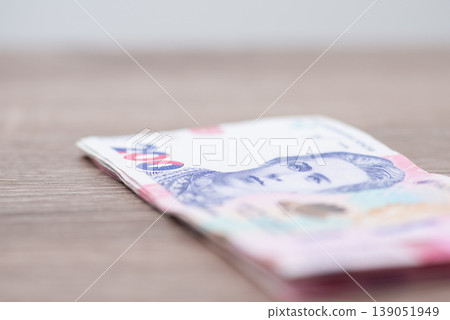 Small pack of 200 hryvnia bills on the wooden table. Ukrainian paper money, cash money concept, close up Small pack of 200 hryvnia bills on the wooden table. Ukrainian paper money, cash money concept, close up 139051949