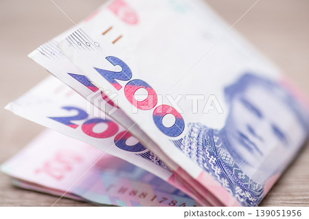 Macro image of ukrainian 200 hryvnia banknotes, cash concept. Focus on the numbers of money bills, portrait of famous poetess Lesya Ukrainka Macro image of ukrainian 200 hryvnia banknotes, cash concept. Focus on the numbers of money bills, portrait of famous poetess Lesya Ukrainka 139051956