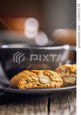 Almond Biscotti cantuccini and Coffee Cup on Rustic Plate Close-Up Breakfast Snack Photograph Almond Biscotti cantuccini and Coffee Cup on Rustic Plate Close-Up Breakfast Snack Photograph 139052176