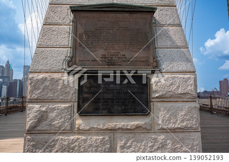New york, usa august 15,2024. Brooklyn bridge historical plaques providing information about its original construction and past reconstruction, with manhattan skyline 139052193