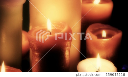 Group of burning wax candles on black background side view detailed stock photo Group of burning wax candles on black background side view detailed stock photo 139052216