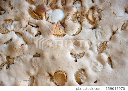Detailed closeup top view of a freshly baked homemade apple pie texture with apple slices and golden crust. Detailed closeup top view of a freshly baked homemade apple pie texture with apple slices and golden crust. 139052970