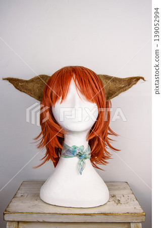 Mannequin head with red wig and felt animal ears for costume design Mannequin head with red wig and felt animal ears for costume design 139052994