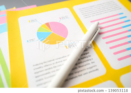 A document with a graph and a pen placed on it. A document with a graph and a pen placed on it. 139053118