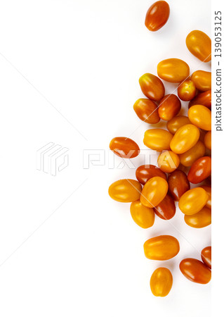 Vibrant cherry tomatoes spread on a white background. Ideal for food photography and healthy eating content, culinary websites and recipe blogs. Copy Space. Selective focus Vibrant cherry tomatoes spread on a white background. Ideal for food photography and healthy eating content, culinary websites and recipe blogs. Copy Space. Selective focus 139053125