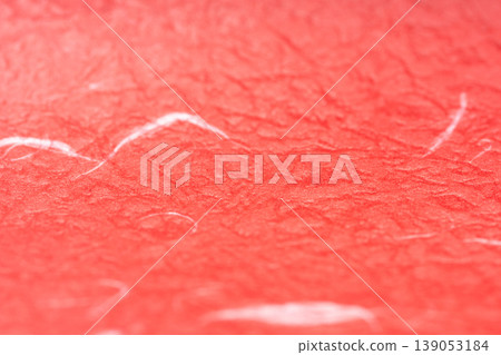 Close-up of the texture of red Japanese paper with raised fibers. Close-up of the texture of red Japanese paper with raised fibers. 139053184