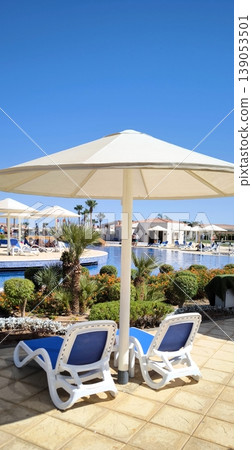 Tropical oasis: resort pool under the scorching sun Tropical oasis: resort pool under the scorching sun 139053501