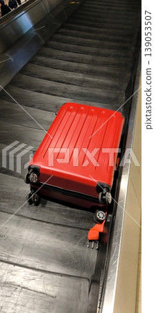 Bright red suitcase on the baggage belt at the airport 139053507