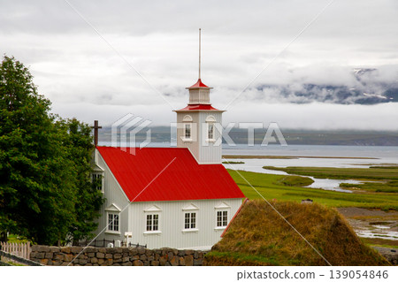 Iceland, a Nordic island nation: Løivaus, near Akureyri, featuring traditional turfhouses and a church. Iceland, a Nordic island nation: Løivaus, near Akureyri, featuring traditional turfhouses and a church. 139054846