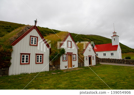 Iceland, a Nordic island nation: Løivaus, near Akureyri, featuring traditional turfhouses and a church. Iceland, a Nordic island nation: Løivaus, near Akureyri, featuring traditional turfhouses and a church. 139054906
