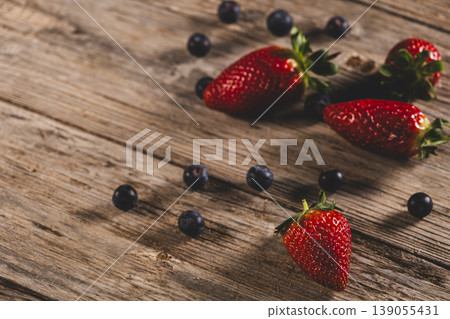 Fresh Blueberries and Strawberries on Wooden Surface. 139055431