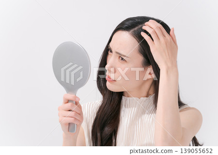 A woman suffering from scalp problems A woman suffering from scalp problems 139055652