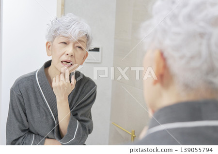 Senior woman suffering from tooth decay Senior woman suffering from tooth decay 139055794