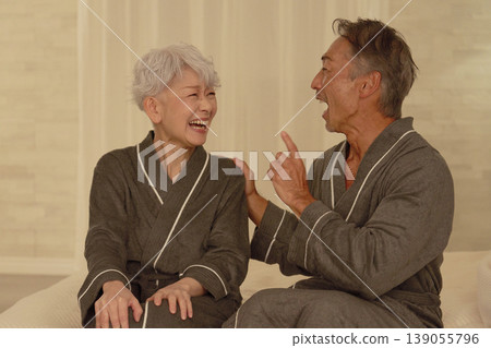Senior couple having a conversation in the bedroom at night Senior couple having a conversation in the bedroom at night 139055796