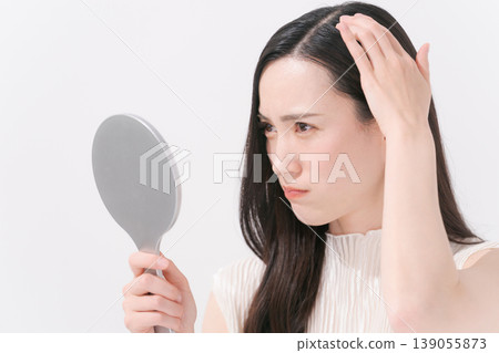 A woman suffering from scalp problems A woman suffering from scalp problems 139055873