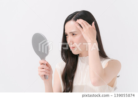 A woman suffering from scalp problems A woman suffering from scalp problems 139055874