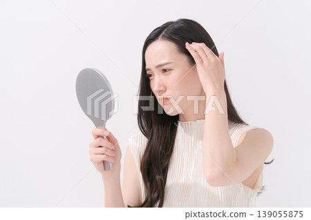 A woman suffering from scalp problems A woman suffering from scalp problems 139055875