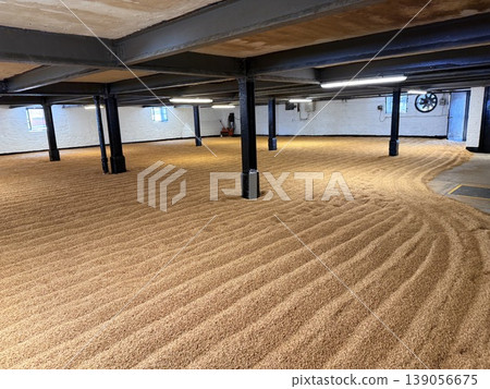 A traditional floor malting process at a whisky distillery on the Isle of Islay in Scotland. A traditional floor malting process at a whisky distillery on the Isle of Islay in Scotland. 139056675