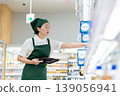 A woman who manages merchandise at a supermarket 139056941