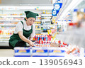 A woman who manages merchandise at a supermarket 139056943