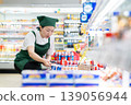 A woman who manages merchandise at a supermarket 139056944
