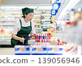 A woman who manages merchandise at a supermarket 139056946