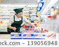 A woman who manages merchandise at a supermarket 139056948