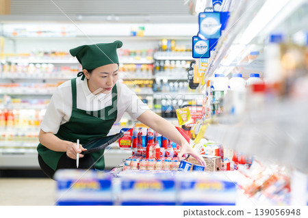 A woman who manages merchandise at a supermarket A woman who manages merchandise at a supermarket 139056948