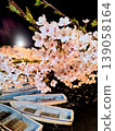 Cherry blossoms and boats floating on the water's surface 139058164