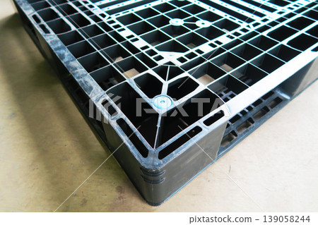 A scene of a single plastic pallet in a logistics warehouse. A scene of a single plastic pallet in a logistics warehouse. 139058244