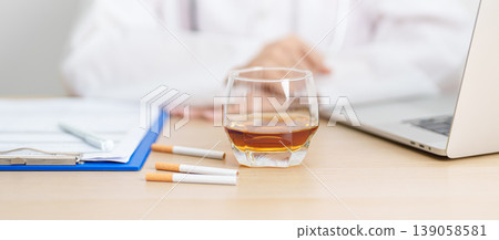 doctor hand making stop sign to refuse whiskey and breaking cigarette, quit smoking and drinking for healthy liver and lung, World No Tobacco and No Alcohol Day and stop alcohol addiction concept doctor hand making stop sign to refuse whiskey and breaking cigarette, quit smoking and drinking for healthy liver and lung, World No Tobacco and No Alcohol Day and stop alcohol addiction concept 139058581