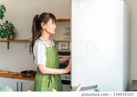 Cooking, cooking for yourself, middle-aged woman taking ingredients out of the refrigerator Cooking, cooking for yourself, middle-aged woman taking ingredients out of the refrigerator 139059105