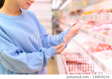 A woman choosing products at the supermarket A woman choosing products at the supermarket 139059238