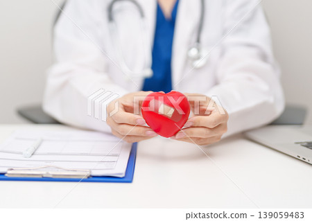 Doctor hand holding red heart shape in hospital. love, donor, world heart day, world health day, CSR donation and Insurance concepts Doctor hand holding red heart shape in hospital. love, donor, world heart day, world health day, CSR donation and Insurance concepts 139059483