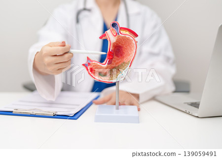 Doctor with Gastric anatomy model. Gastroenterologist consultation, stomach diseases and ulcers, November stomach cancer, Gastroesophageal Reflux Disease, GERD, Acid reflux and healthcare medical Doctor with Gastric anatomy model. Gastroenterologist consultation, stomach diseases and ulcers, November stomach cancer, Gastroesophageal Reflux Disease, GERD, Acid reflux and healthcare medical 139059491