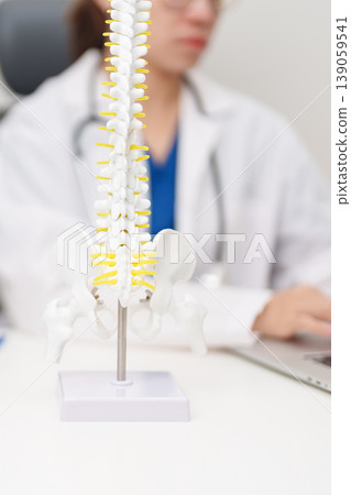 Doctor with human Spine anatomy model. Spinal Cord Disorder and disease, Back pain, Lumbar, Sacral pelvis, Cervical neck, Thoracic, Coccyx, Orthopedist, chiropractic, Office Syndrome and health Doctor with human Spine anatomy model. Spinal Cord Disorder and disease, Back pain, Lumbar, Sacral pelvis, Cervical neck, Thoracic, Coccyx, Orthopedist, chiropractic, Office Syndrome and health 139059541