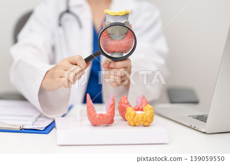 Doctor with human Thyroid anatomy model. Hyperthyroidism, Hypothyroidism, Hashimoto Thyroiditis, Thyroid Tumor and Cancer, Postpartum, Papillary Carcinoma and Health concept Doctor with human Thyroid anatomy model. Hyperthyroidism, Hypothyroidism, Hashimoto Thyroiditis, Thyroid Tumor and Cancer, Postpartum, Papillary Carcinoma and Health concept 139059550