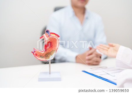 Doctor with Gastric anatomy model. Gastroenterologist consultation, stomach diseases and ulcers, November stomach cancer, Gastroesophageal Reflux Disease, GERD, Acid reflux and healthcare medical Doctor with Gastric anatomy model. Gastroenterologist consultation, stomach diseases and ulcers, November stomach cancer, Gastroesophageal Reflux Disease, GERD, Acid reflux and healthcare medical 139059650